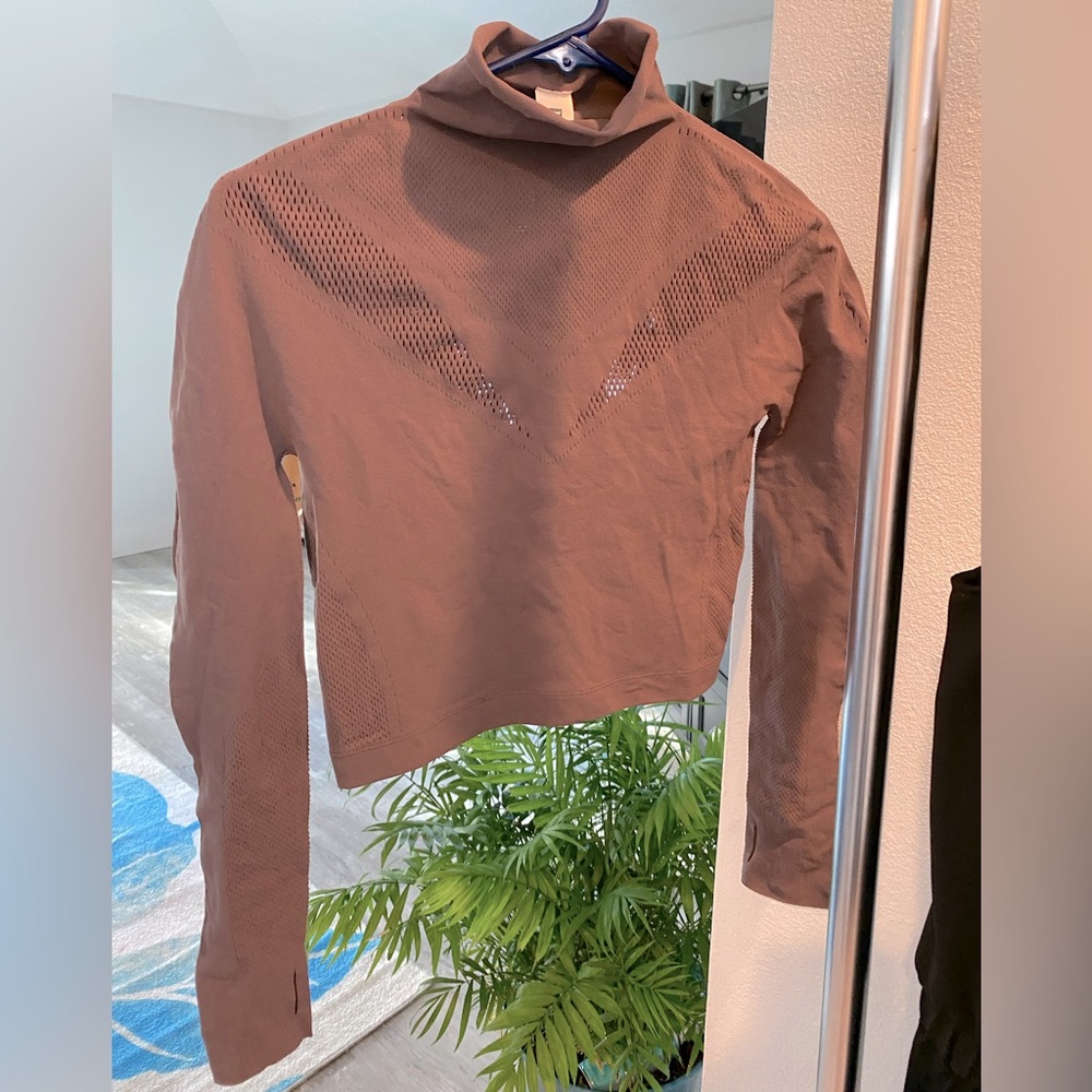 Semi-cropped, laser cut top by Fabletics. Never worn. NWT